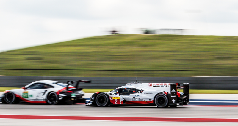 A Porsche LMP1 passing one of the Porsche GTE Pro cars.